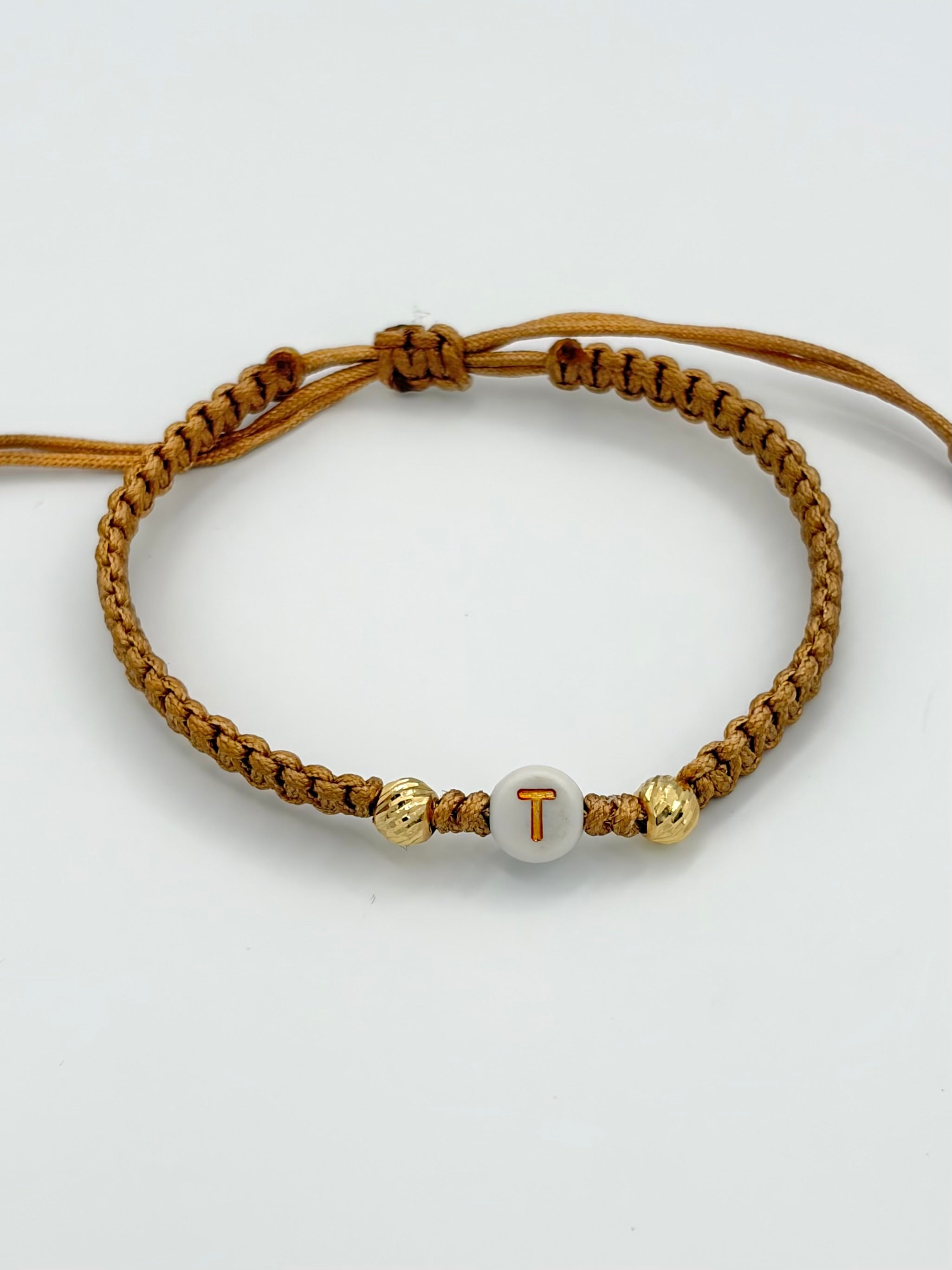 Pulsera tejida Letra T 2BD #5 hilo beige Oro amarillo 18k 0,15 Gr