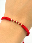 Pulsera tejida 5BD #3 balines de neopreno rojos hilo rojo Oro amarillo 18k 0,20 Gr